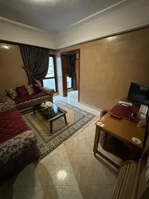 a living room with a couch and a table at Hotel Mounia in Fès