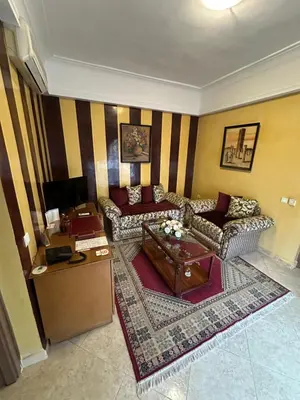 a living room with couches and a coffee table at Hotel Mounia in Fès