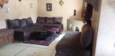 a living room with leather couches and a table at La Kasbah d'Ouzoud in Ouzoud