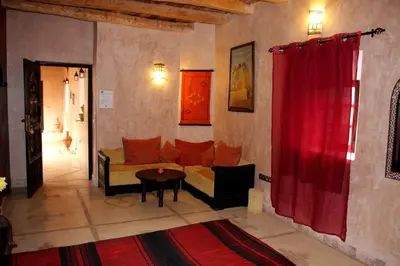a living room with a couch and a red curtain at La Kasbah d'Ouzoud in Ouzoud