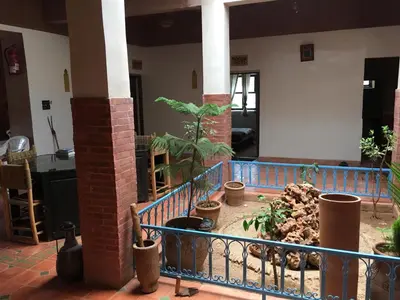 a room with a fence and some plants at Maison D'hôtes Dar Afra in Aït Ziri