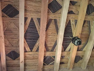 a ceiling of a room with wooden beams at Maison D'hôtes Dar Afra in Aït Ziri