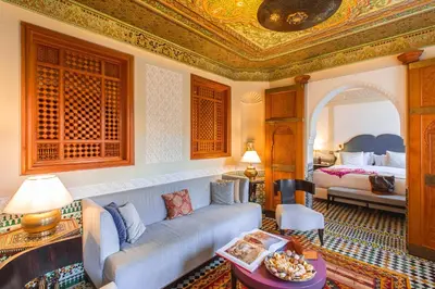 a living room with a couch and a bed at Palais Faraj Suites & Spa in Fès