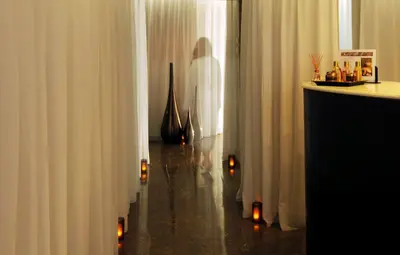a room with white curtains and candles on the floor at Palais Faraj Suites & Spa in Fès