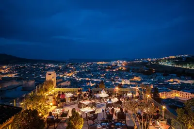 a view of a city at night at Palais Faraj Suites & Spa in Fès