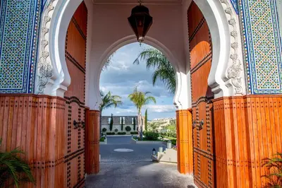 an archway in a building with a view of a courtyard at Palais Faraj Suites & Spa in Fès