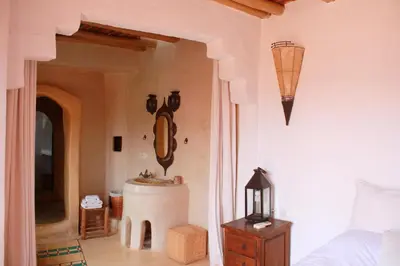 a bathroom with a sink in a room with a bed at Riad Cascades d'Ouzoud in Ouzoud