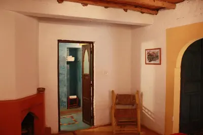 a hallway with a mirror and a chair in a room at Riad Cascades d'Ouzoud in Ouzoud