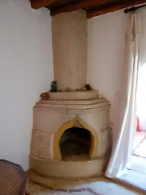 a fireplace in the corner of a room at Riad Cascades d'Ouzoud in Ouzoud