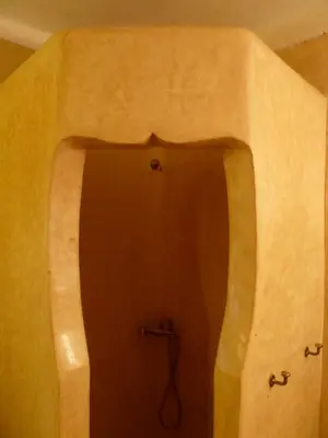 a bathroom with a shower in the middle of a wall at Riad Cascades d'Ouzoud in Ouzoud