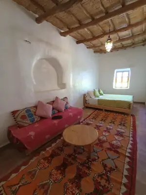 a living room with a couch and a table at Kasbah Auberge Bassou in Nkob