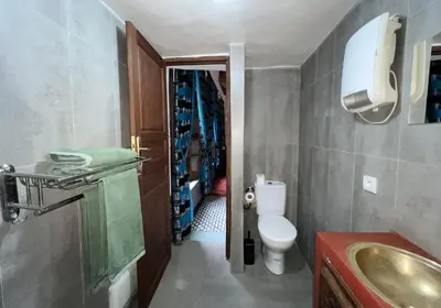 a small bathroom with a toilet and a sink at Riad Dezayn in Fès