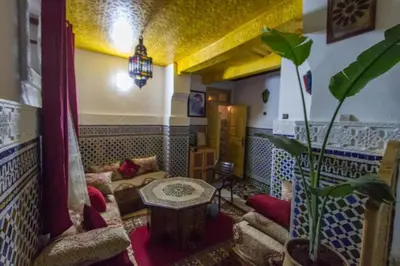 a living room with a couch and a table at Dar Zin in Fès