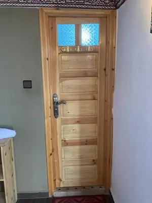a wooden door in a room with a window at Dar Zin in Fès