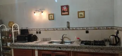 a kitchen with a sink and a stove at Beautiful & Comfortable Apartment in Fes in Fès