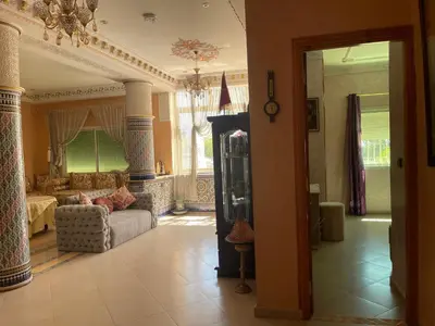 a living room with a couch and a table at Beautiful & Comfortable Apartment in Fes in Fès