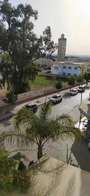 a view of a parking lot with a palm tree at Beautiful & Comfortable Apartment in Fes in Fès