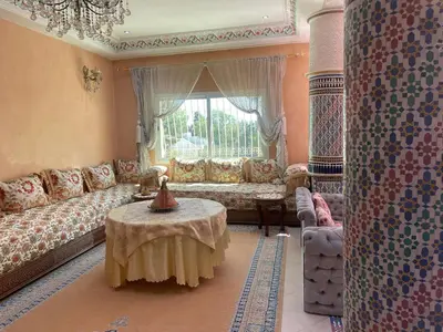 a living room with a couch and a table at Beautiful & Comfortable Apartment in Fes in Fès