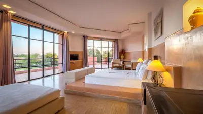 a large bedroom with a bed and a large window at Palmeraie Dar Atlas - Luxury Houses in Marrakech