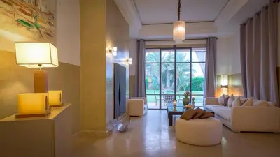 a living room with a couch and a table at Palmeraie Dar Atlas - Luxury Houses in Marrakech