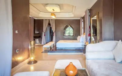 a living room with a bed and a couch at Palmeraie Dar Atlas - Luxury Houses in Marrakech