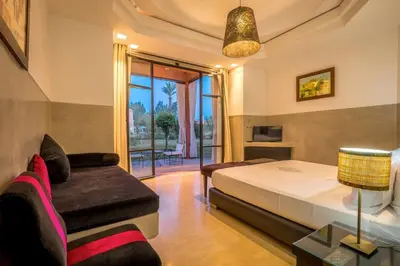 a bedroom with a bed and a couch at Palmeraie Dar Atlas - Luxury Houses in Marrakech