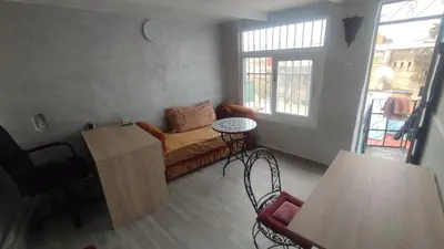 a living room with a couch and a table at Dar Ahl Tadla in Fès