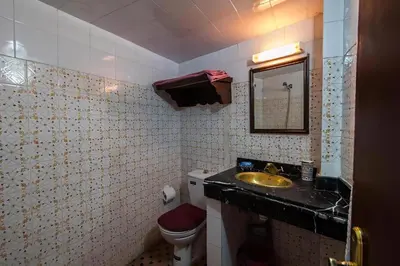 a bathroom with a sink and a toilet and a mirror at Dar Ahl Tadla in Fès