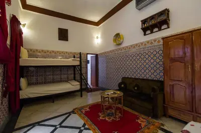 a room with a bunk bed and a couch at Dar Ahl Tadla in Fès