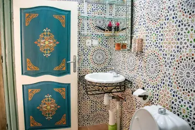 a bathroom with a toilet and a sink in it at Le Petit Riad Maison d'hôtes in Ouarzazate