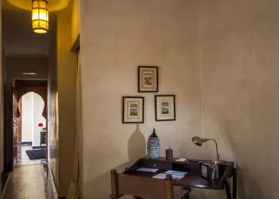a room with a desk and a lamp on a wall at Riad Mayfez Suites & Spa in Fès