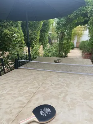 an umbrella and a spatula sitting on a patio at Riad Mayfez Suites & Spa in Fès