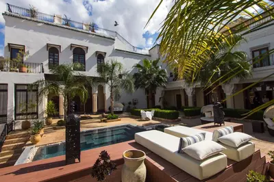 a house with a swimming pool and a villa at Riad Mayfez Suites & Spa in Fès
