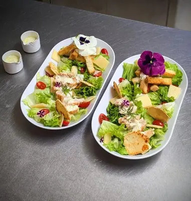 two plates of food on a table with a salad at Riad Mayfez Suites & Spa in Fès