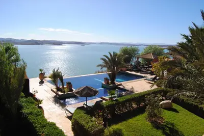 a swimming pool with a view of a body of water at Les Tourmalines in Ouarzazate