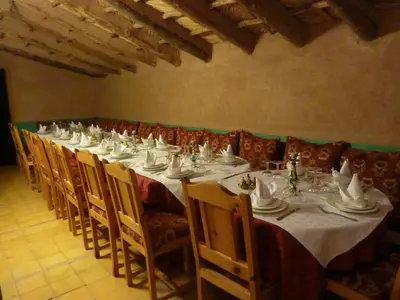 a long dining room with a long table and chairs at Les Tourmalines in Ouarzazate