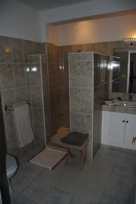 a bathroom with a shower and a toilet and a sink at Les Tourmalines in Ouarzazate