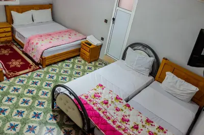 a bedroom with two beds and a mirror at Hotel Palace Zaida in Zaida