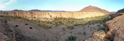 arial view of a canyon with trees and mountains at Amoudou Lodge Camp in Tissint