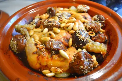 an orange bowl of food with meat and nuts at Amoudou Lodge Camp in Tissint