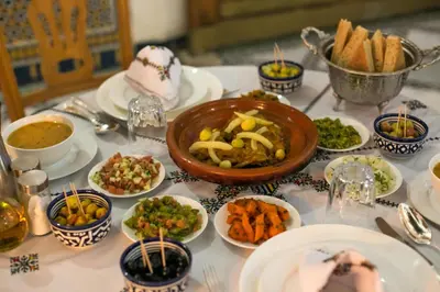a table topped with plates of food and bowls of food at Riad Fes Iline in Fès