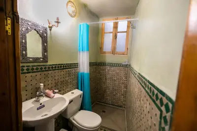 a bathroom with a toilet and a sink at Riad Fes Iline in Fès