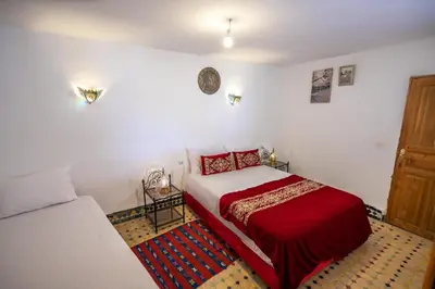 a bedroom with a bed and a couch at Riad Fes Iline in Fès