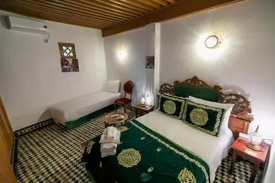 a bedroom with a bed and a couch in a room at Riad Fes Iline in Fès