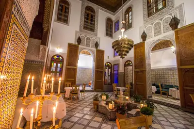a large room with tables and chairs in a building at Riad Fes Iline in Fès