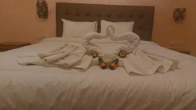 a white bed with an elephant made out of towels at Kasbat Aferdou in Er Rachidia