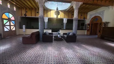 a living room with couches and chairs in a building at Kasbat Aferdou in Er Rachidia