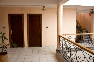 a balcony with two doors and a staircase in a building at Hotel Bab Boujloud in Fès
