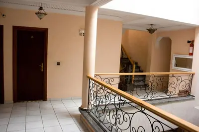 a balcony with a railing and a staircase in a building at Hotel Bab Boujloud in Fès