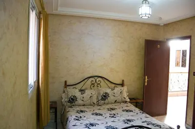 a bedroom with a bed and a window at Hotel Bab Boujloud in Fès